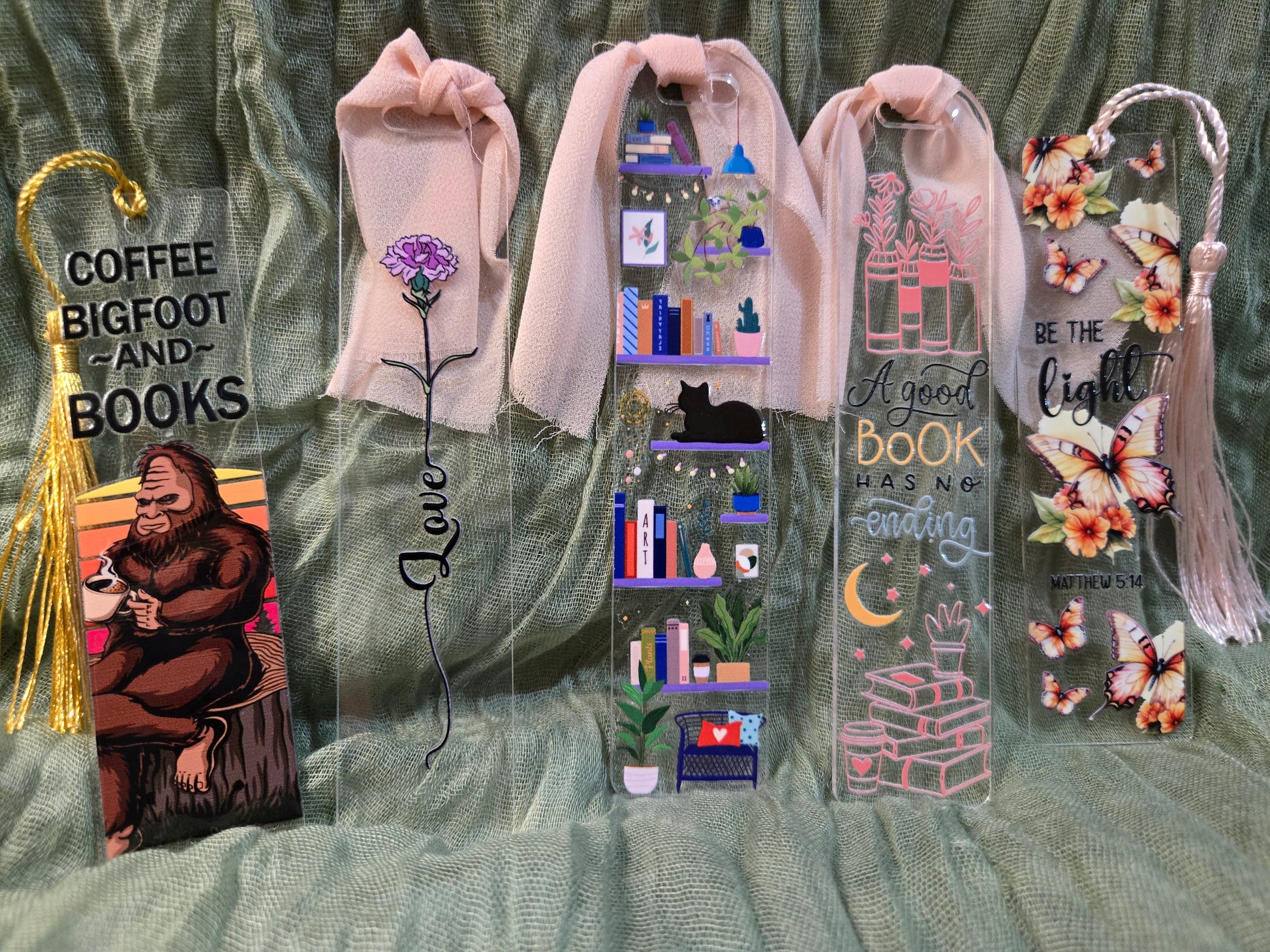 Collection of decorative bookmarks with various designs on a textured fabric background.